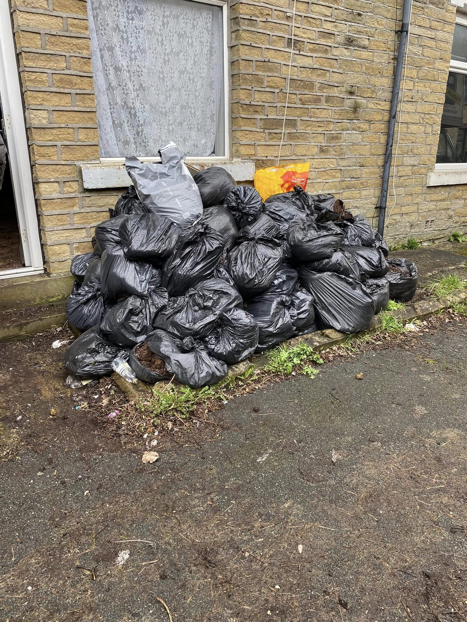 Black waste sacks grouped outside a property