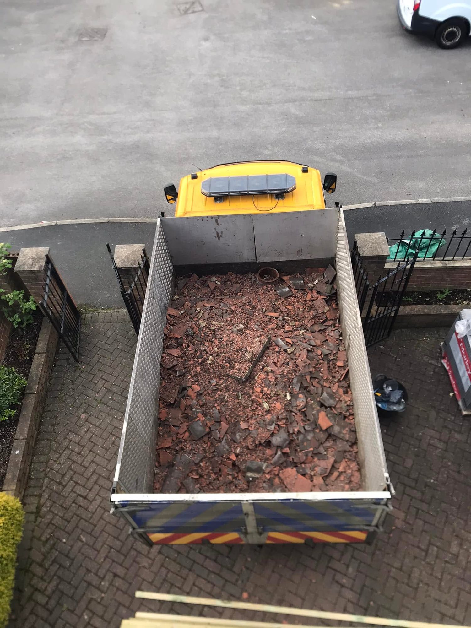 Waste vehicle bed filled with brick rubble