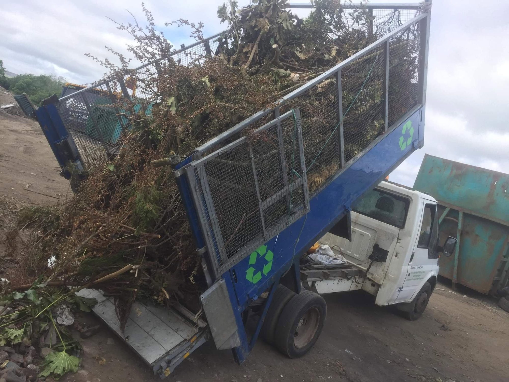 Waste truck loaded with branches and garden cuttings