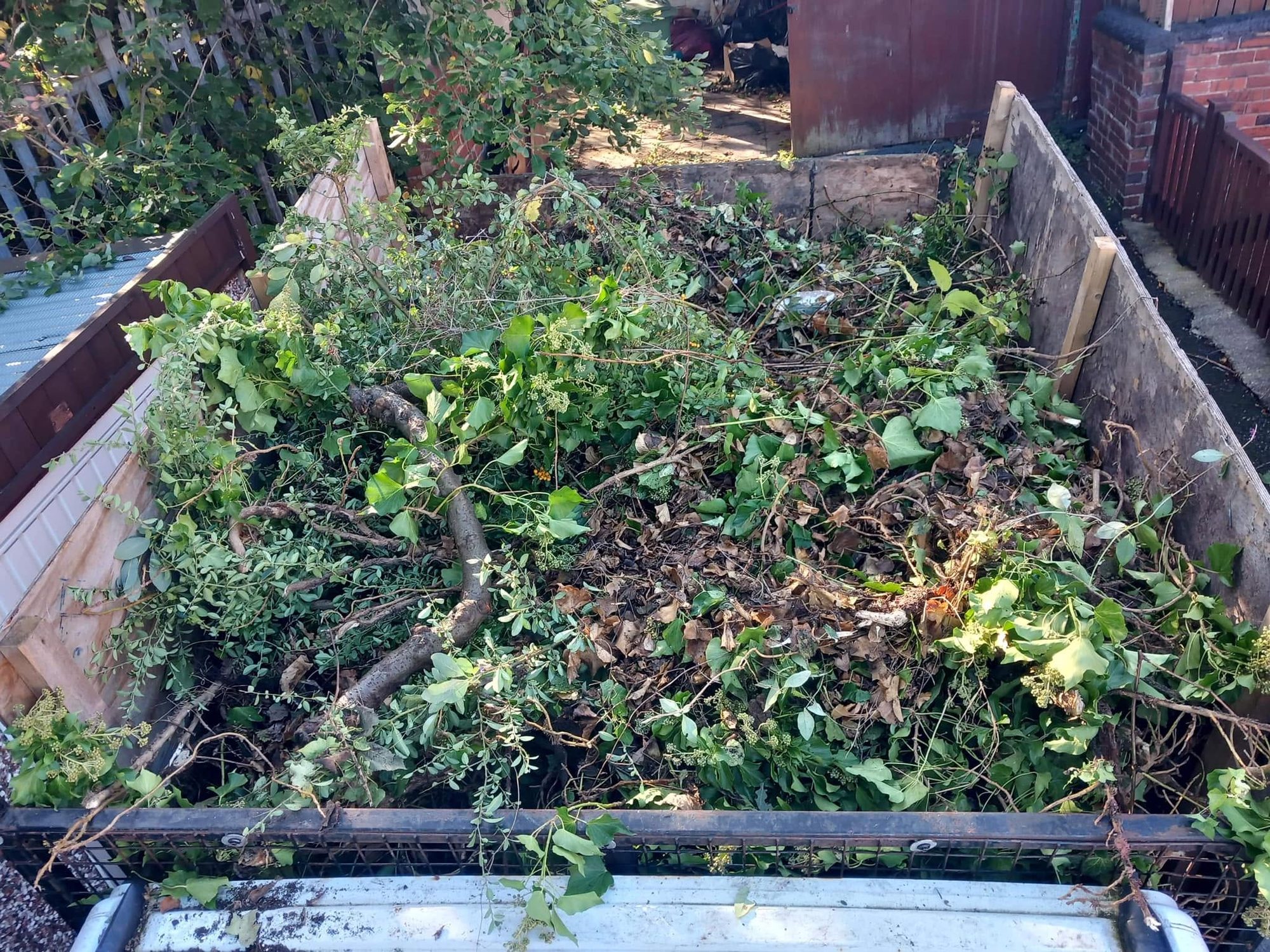 Collection vehicle loaded with cut branches and foliage