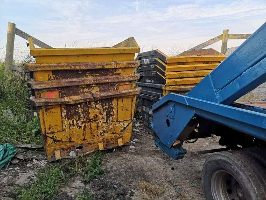Low-resolution waste containers beside a truck