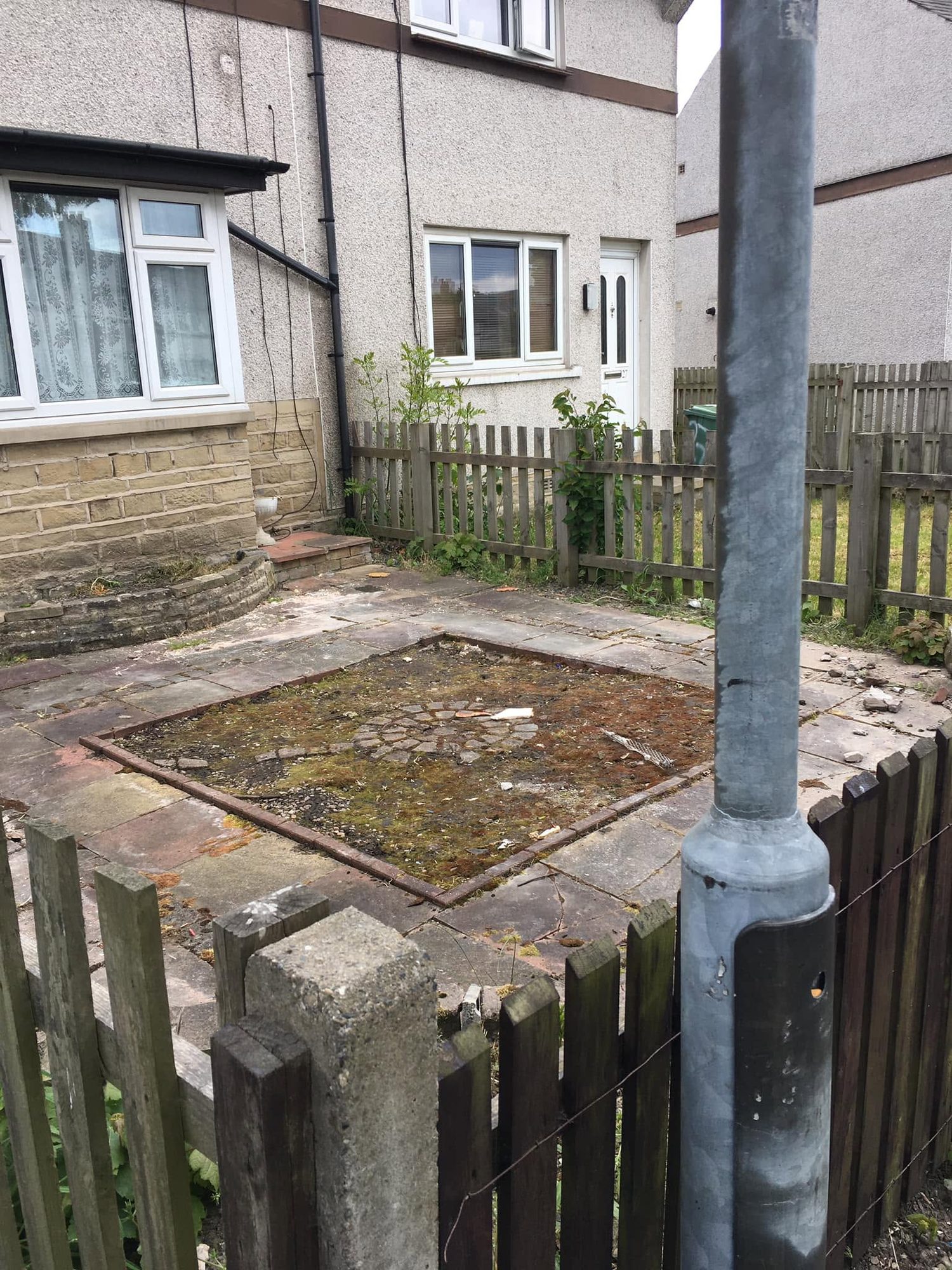 Residential paved yard with a foreground post