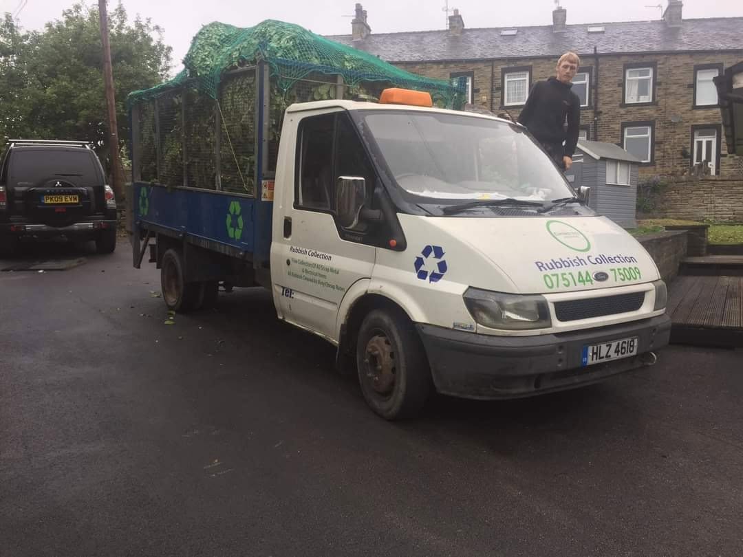 Waste collection truck and worker on a residential street