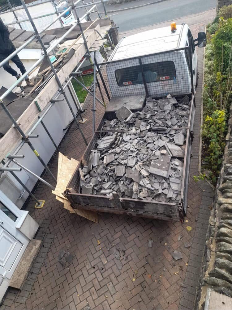 Collection truck containing discarded roof tiles