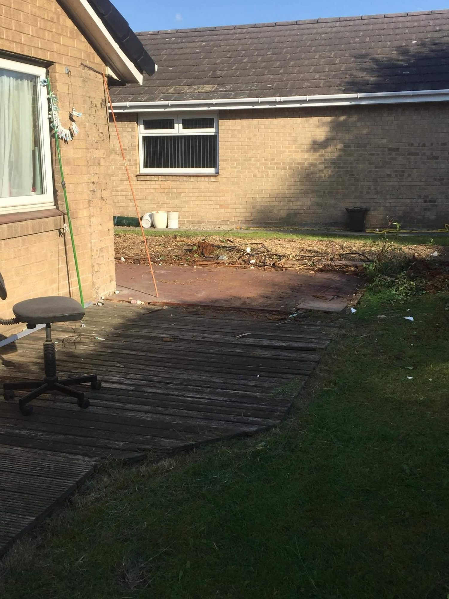 House-side garden with lawn and decking