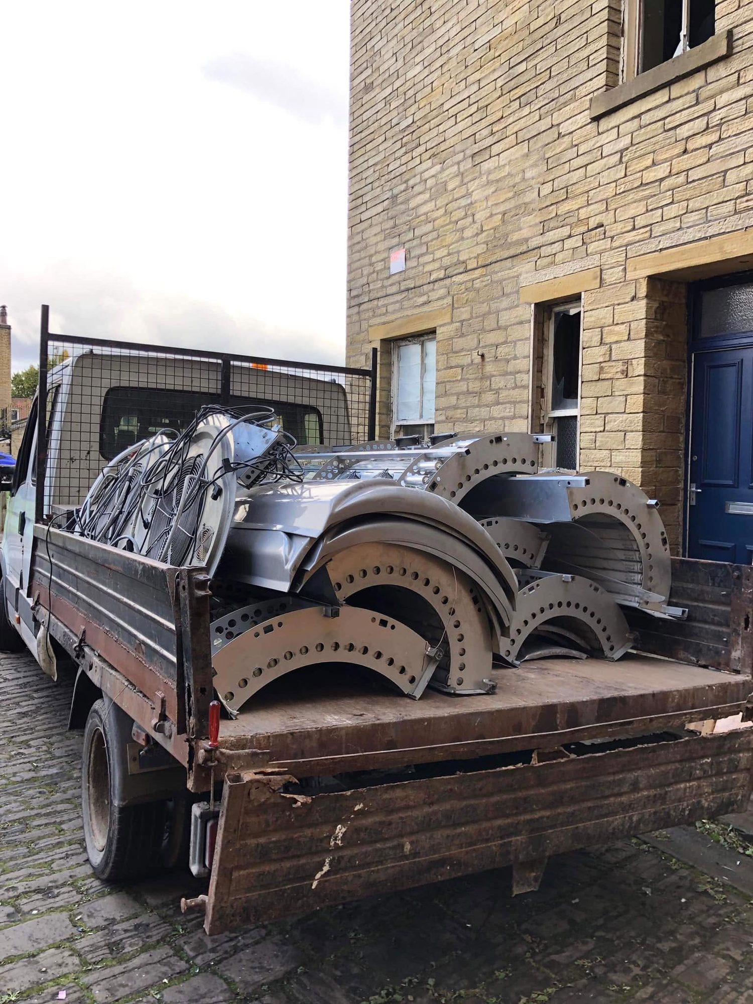Waste truck carrying bulky metal and commercial equipment